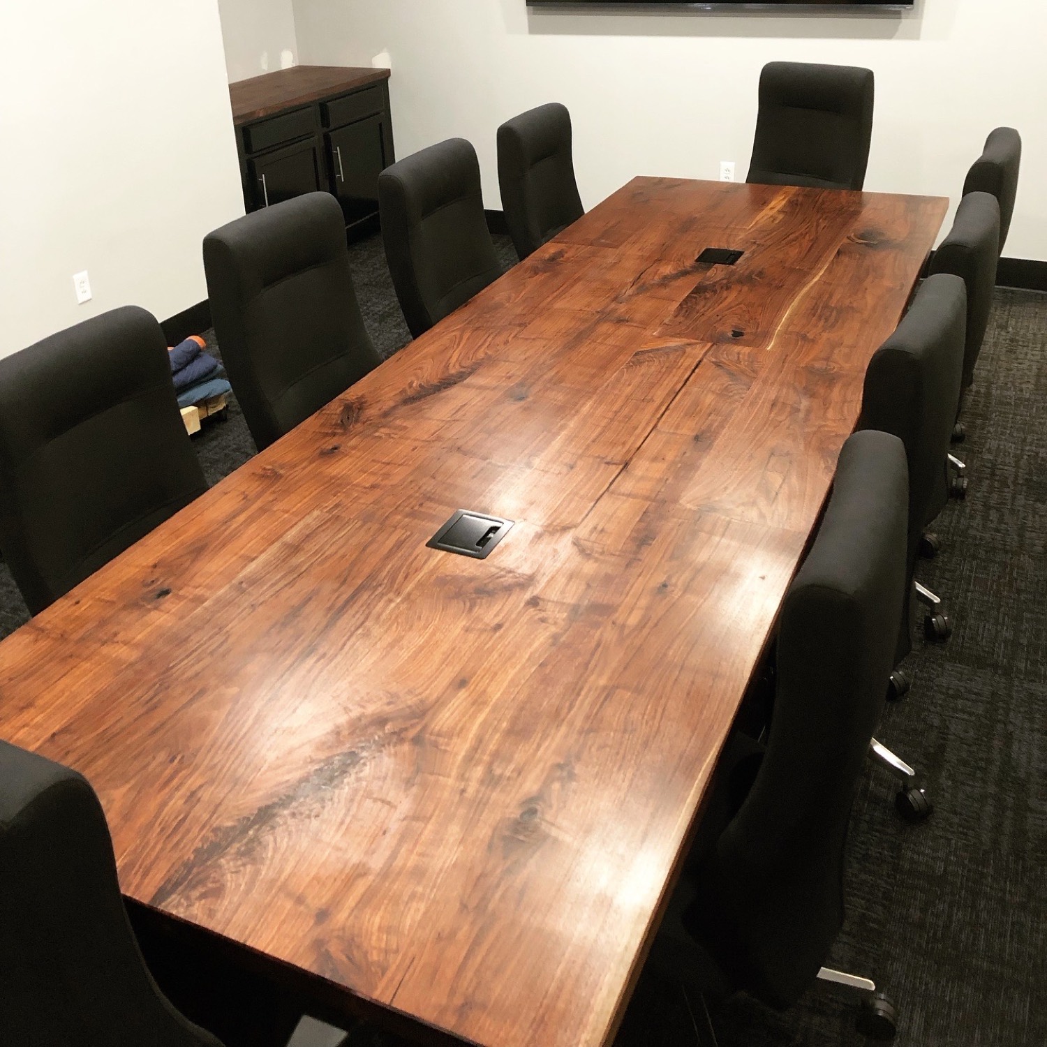 Large live-edge walnut conference table in a boardroom