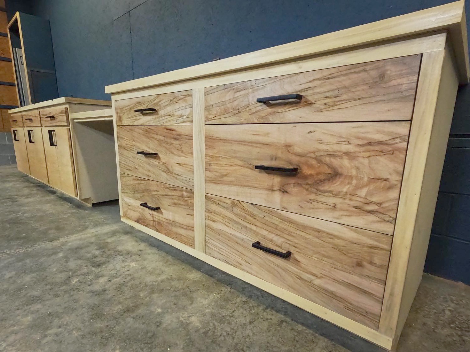 Maple workshop cabinets with drawers and black pulls